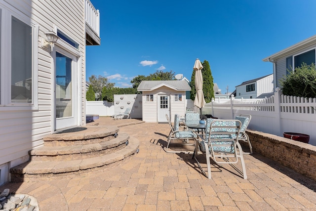 view of patio / terrace with a storage shed