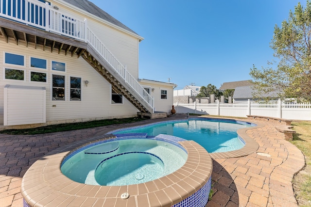 view of pool with an in ground hot tub and a patio area