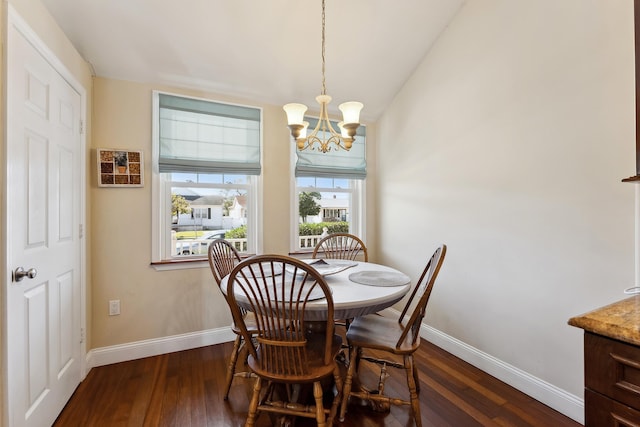 dining area featuring dark hardwood / wood-style floors and an inviting chandelier