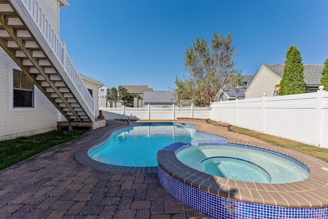 view of pool with an in ground hot tub