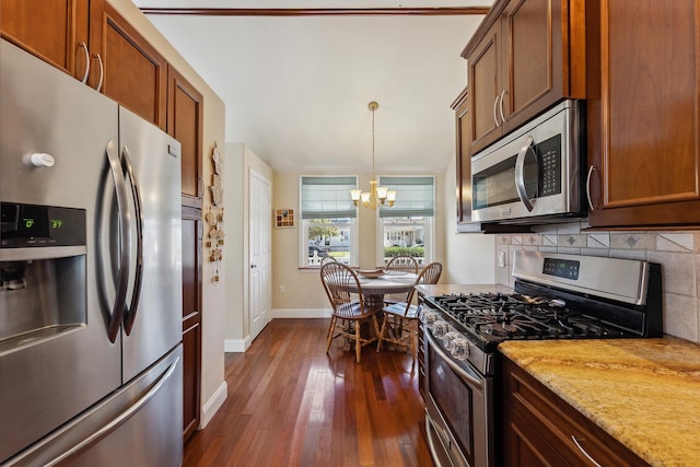 kitchen featuring light stone countertops, dark hardwood / wood-style flooring, tasteful backsplash, stainless steel appliances, and an inviting chandelier