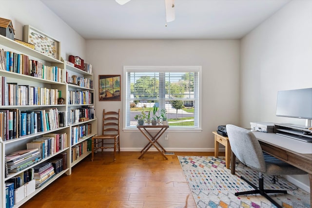 office with hardwood / wood-style flooring and ceiling fan