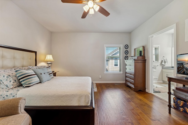 bedroom featuring ceiling fan, ensuite bathroom, and dark hardwood / wood-style floors