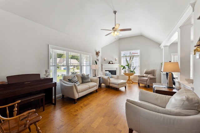 living room with ceiling fan, a wealth of natural light, light hardwood / wood-style flooring, and lofted ceiling