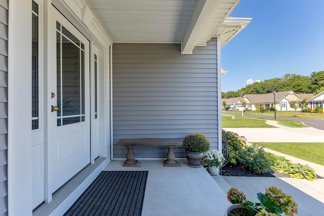 view of exterior entry featuring a porch