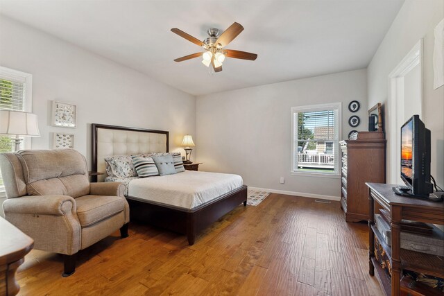 bedroom with ceiling fan and hardwood / wood-style floors