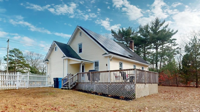 back of house with a yard and a deck