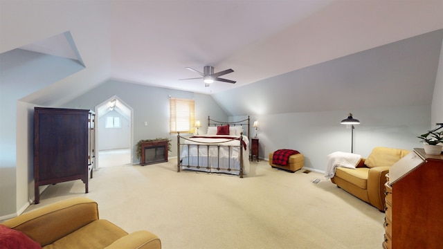 bedroom with ceiling fan, light colored carpet, and vaulted ceiling