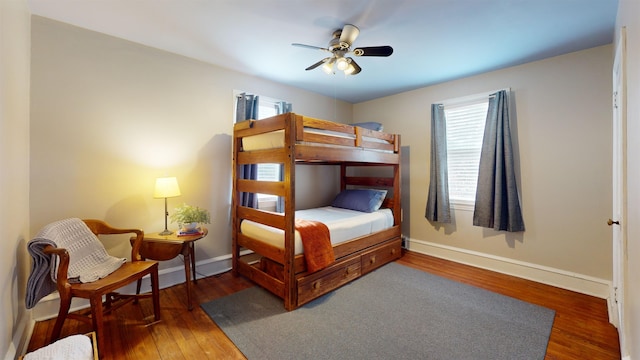 bedroom with ceiling fan and dark wood-type flooring