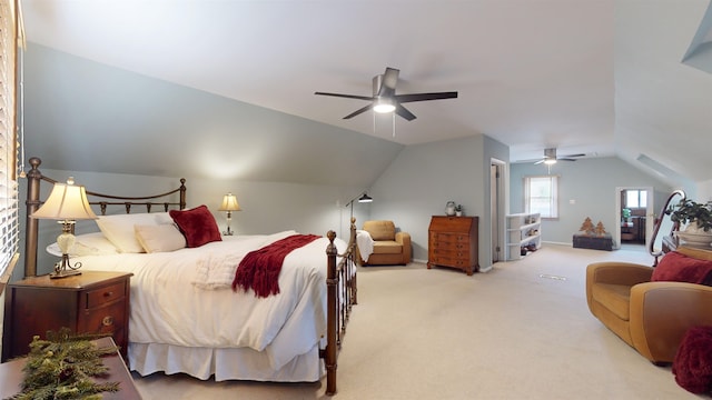 carpeted bedroom with ceiling fan and vaulted ceiling