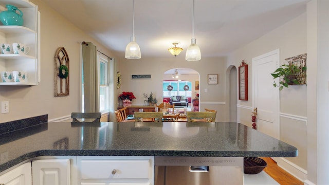 kitchen featuring pendant lighting, white cabinetry, ceiling fan, and a kitchen breakfast bar