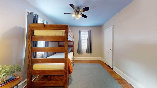 bedroom with ceiling fan and dark hardwood / wood-style floors