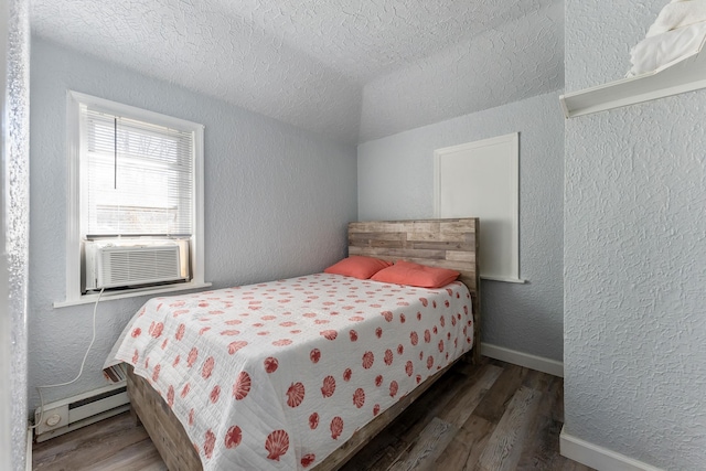 bedroom featuring a baseboard heating unit, cooling unit, a textured ceiling, and dark hardwood / wood-style floors