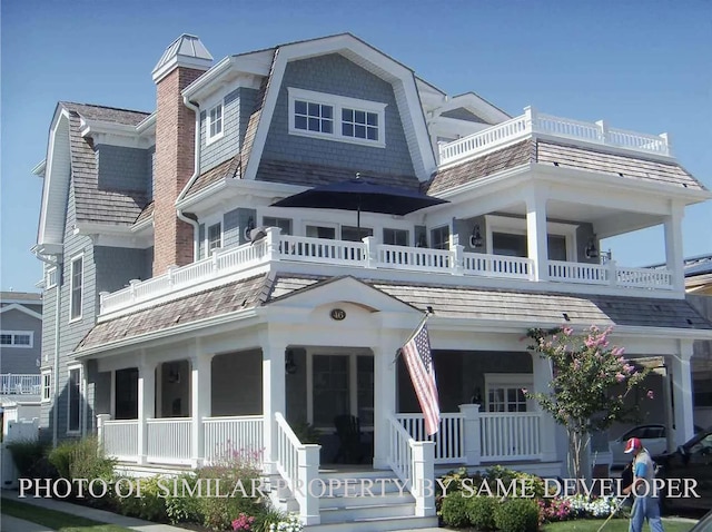 view of front of property with a balcony and covered porch