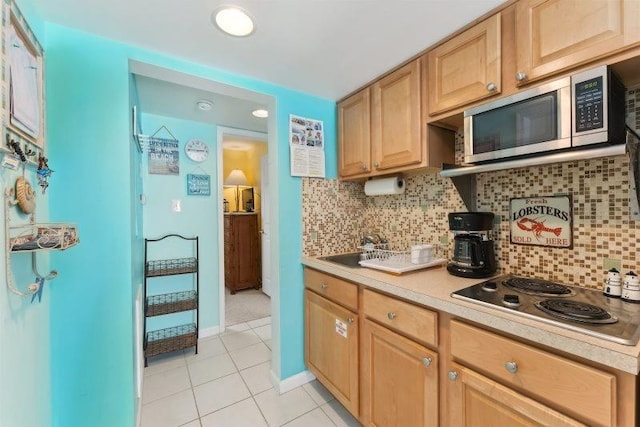 7203 Atlantic Ave Unit 302, Wildwood Crest, NJ 08260 - kitchen with appliances with stainless steel finishes, light tile patterned flooring, light countertops, light brown cabinetry, and decorative backsplash