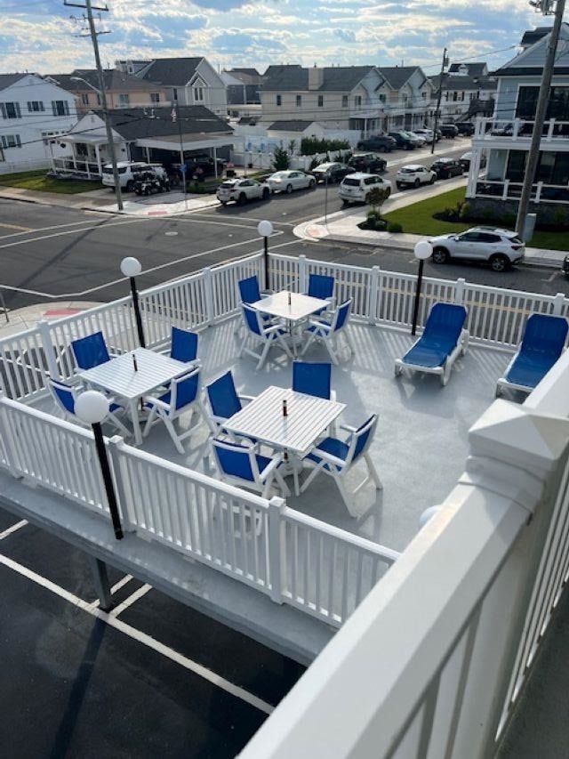 7203 Atlantic Ave Unit 302, Wildwood Crest, NJ 08260 - wooden terrace featuring outdoor dining space and a residential view