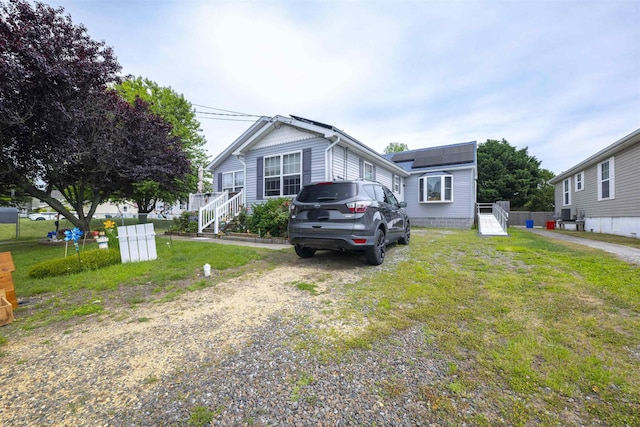 4 Rutledge Ave, Del Haven, NJ 08251 - view of front of home with roof mounted solar panels, a front yard, and driveway