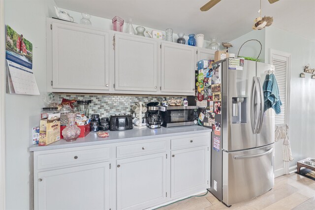 4 Rutledge Ave, Del Haven, NJ 08251 - kitchen with stainless steel appliances, light countertops, white cabinets, a ceiling fan, and tasteful backsplash