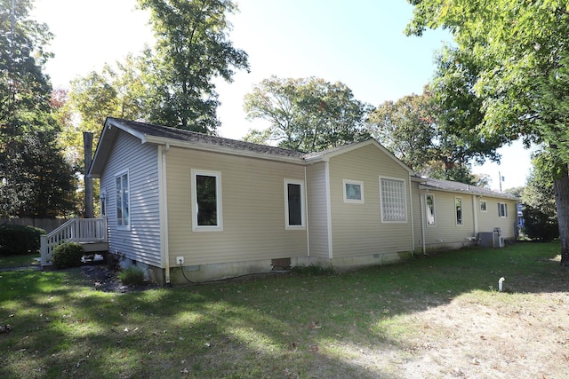 rear view of property with a yard and central AC unit