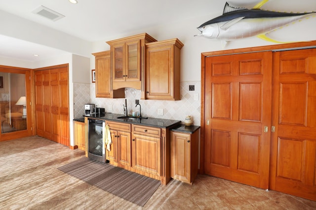 kitchen featuring backsplash, sink, and wine cooler