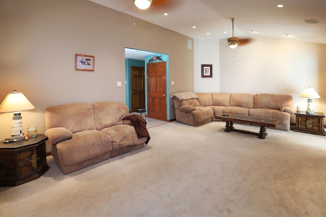 carpeted living room with vaulted ceiling and ceiling fan