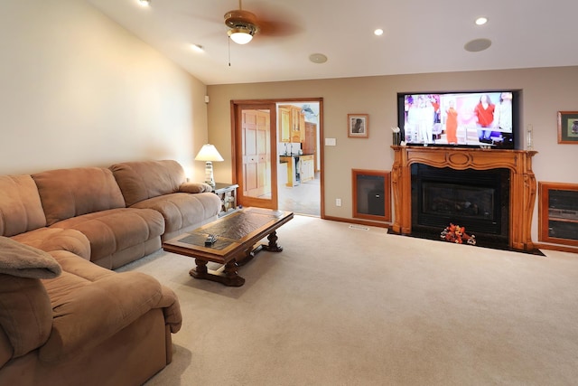 living room featuring light colored carpet, vaulted ceiling, and ceiling fan