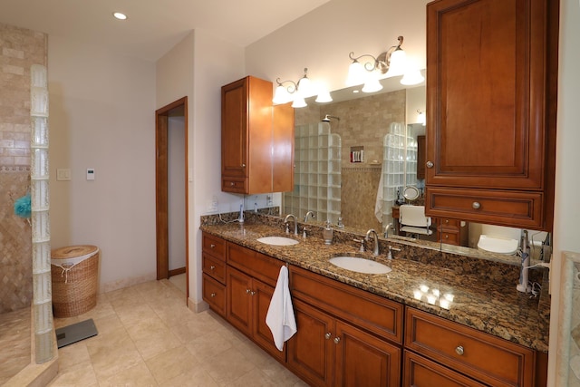 bathroom featuring tile patterned flooring, vanity, and tiled shower