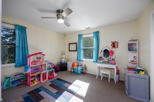 rec room with ceiling fan and carpet floors