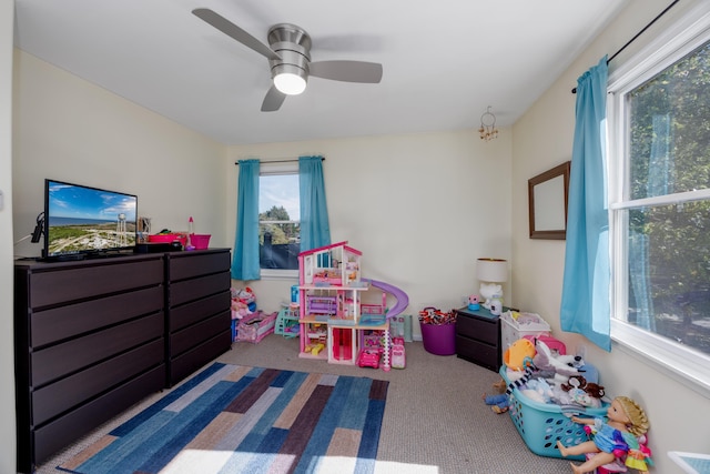 playroom with carpet and ceiling fan with notable chandelier