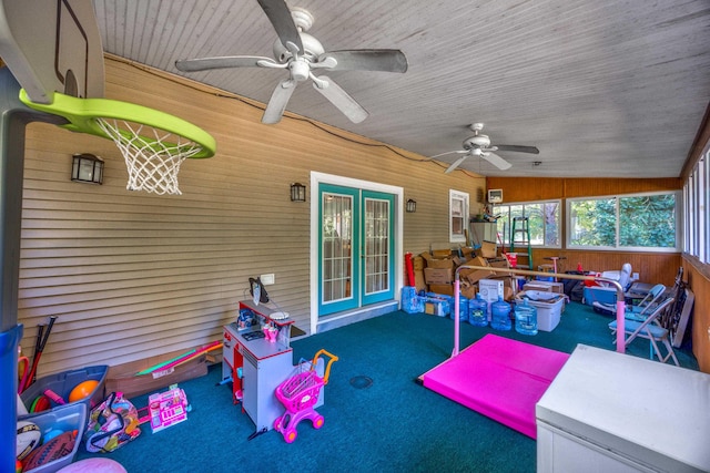 sunroom with ceiling fan and lofted ceiling