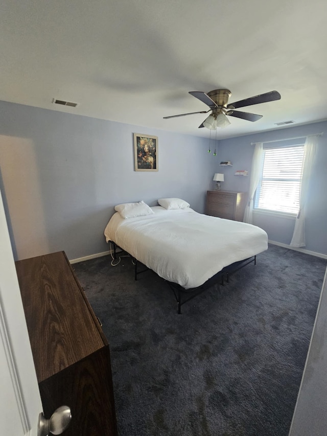 carpeted bedroom with baseboards, visible vents, and ceiling fan