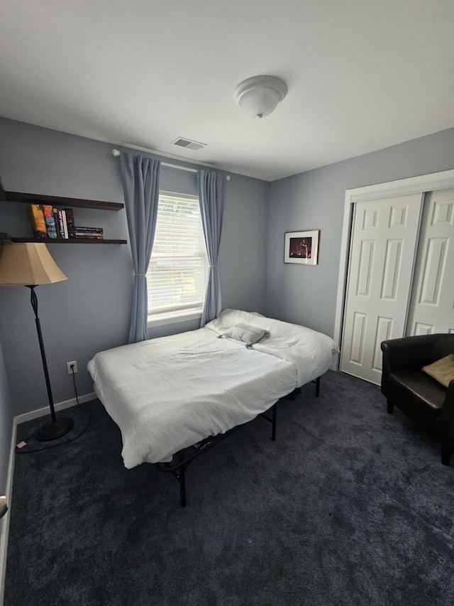 carpeted bedroom with baseboards, a closet, and visible vents