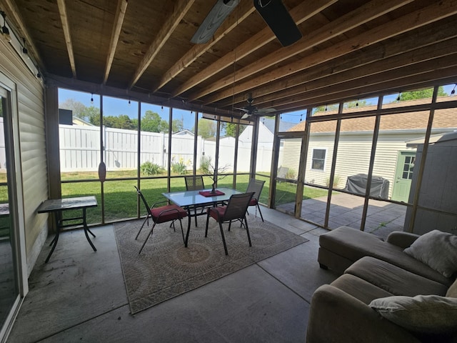 sunroom / solarium featuring outdoor dining space and ceiling fan