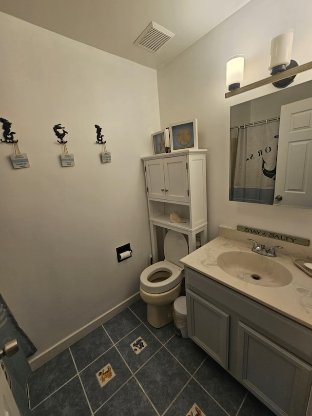bathroom featuring visible vents, tile patterned flooring, vanity, baseboards, and toilet