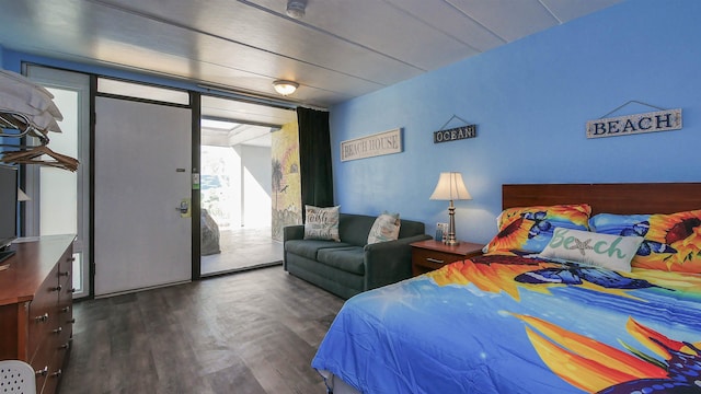 bedroom featuring dark wood-style floors and access to exterior
