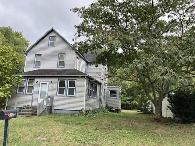 back of property featuring a lawn