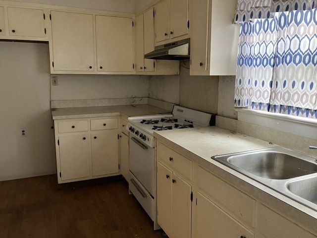 kitchen with dark hardwood / wood-style flooring, white cabinetry, white gas stove, and sink