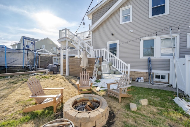 220 E 21st Ave, North Wildwood, NJ 08260 - back of house featuring fence, an outdoor fire pit, a trampoline, stairway, and a yard