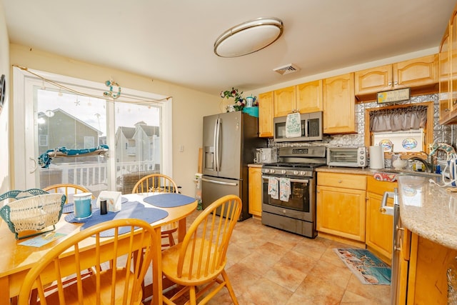 220 E 21st Ave, North Wildwood, NJ 08260 - kitchen featuring tasteful backsplash, stainless steel appliances, a toaster, visible vents, and light brown cabinets