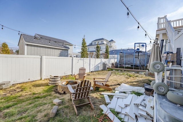 220 E 21st Ave, North Wildwood, NJ 08260 - view of yard featuring a fenced backyard, an outdoor fire pit, and a trampoline