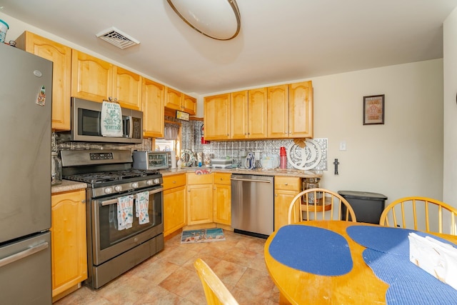 220 E 21st Ave, North Wildwood, NJ 08260 - kitchen featuring light countertops, visible vents, tasteful backsplash, light brown cabinets, and appliances with stainless steel finishes