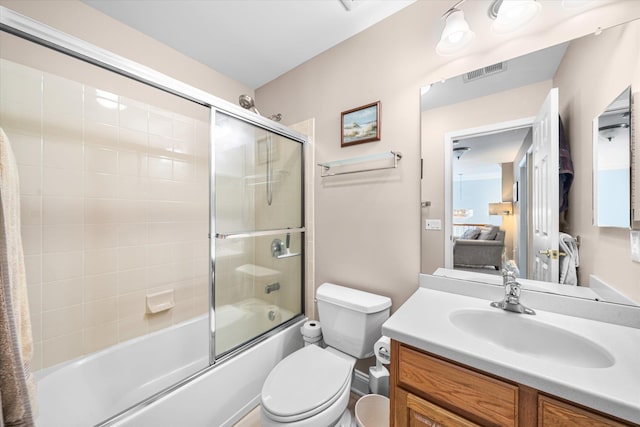 full bathroom featuring shower / bath combination with glass door, vanity, and toilet