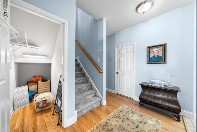 stairway with hardwood / wood-style floors