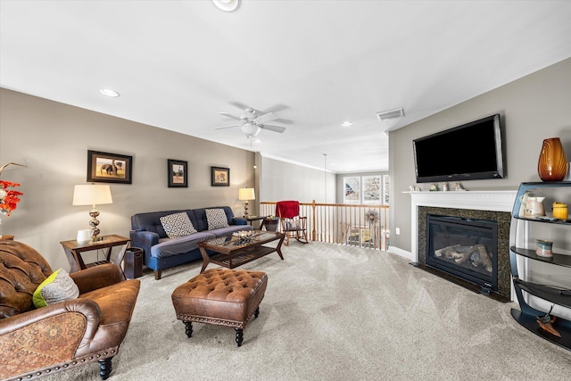 living room featuring ceiling fan, carpet floors, and a high end fireplace