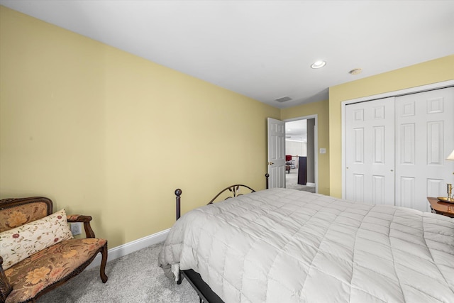 bedroom with light colored carpet and a closet