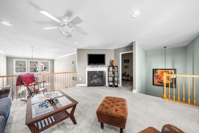 living room with light carpet, ornamental molding, and ceiling fan