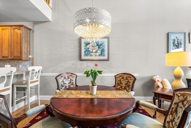 dining area featuring a notable chandelier and wood-type flooring