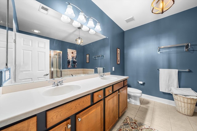 bathroom featuring tile patterned flooring, vanity, a shower with door, and toilet