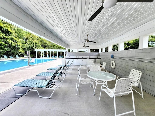 view of swimming pool featuring a patio and ceiling fan