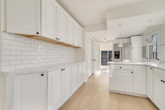 kitchen with white cabinetry and pendant lighting